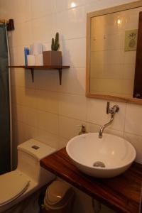 a bathroom with a sink and a toilet and a mirror at Sapa Inka in Montañita +62 photos