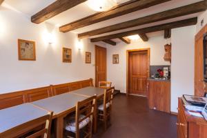 a kitchen and dining room with a table and chairs at Haus Wildbach - Baranek Resorts in Leogang