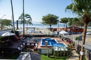 a resort with a swimming pool and a beach at Pousada Quintal do Mar in Ubatuba