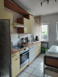 a kitchen with white cabinets and a stove top oven at FERIENWOHNUNG Marina in Bad Ems +13 photos