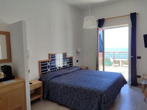 a bedroom with a bed and a door to a patio at Hotel Dania in Sorrento