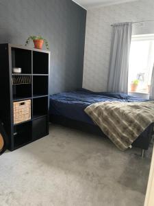 a bedroom with a bed and a book shelf at Östra Tull in Hudiksvall