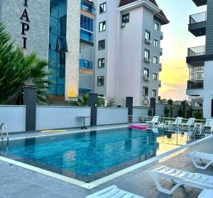 a swimming pool in front of a building at Neridabeachhomes 20 in Alanya