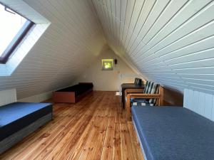 a attic room with two beds and a window at Olivia in Sianozety