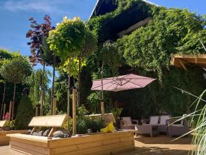 a patio with a table and an umbrella and chairs at Olivia in Sianozety