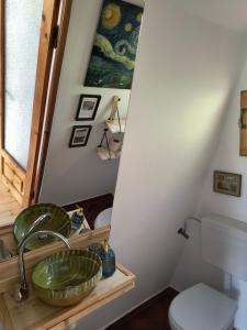 a bathroom with a sink and a toilet at Retreat în padure in Buchin