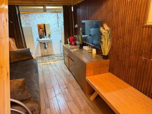 a room with a couch and a tv and a bench at ALKHAWAJAT Guest House in Jerusalem
