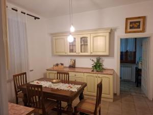 a kitchen with a table and a dining room at L'Olivo , in Tuscany in Bettolle