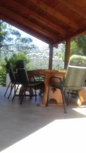 two chairs and a wooden table on a porch at Kuća Mare, 130m od mora in Seline +27 photos
