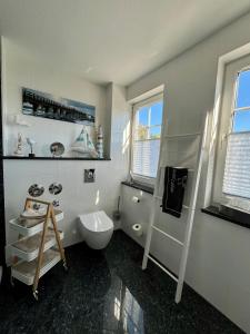 a bathroom with a shower and a toilet and a sink at Schlösschen am Schmachter See in Binz +33 photos