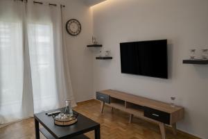 a living room with a flat screen tv on a wall at Lemon Nest in Athens +9 photos