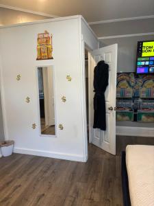 a room with a bed and a mirror and a door at Nice & Cozy 3 bedroom Escape in Waycross