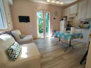 a living room with a couch and a table at Villa dei Cavallucci Marini in Capoliveri