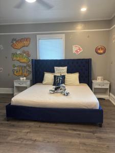 a bed with a blue headboard in a bedroom at Nice & Cozy 3 bedroom Escape in Waycross