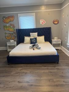 a bed with a blue headboard in a bedroom at Nice & Cozy 3 bedroom Escape in Waycross