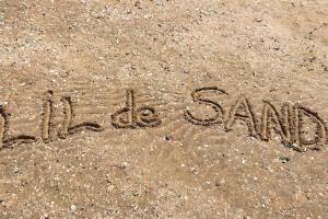 a word written in the sand on the beach at LIL de SAND in Bourcefranc +7 photos