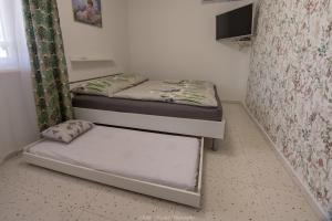 two bunk beds in a room with a window at Apartman Pollux in Nesvady +17 photos