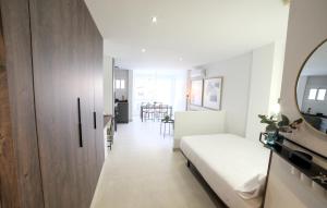 a small bedroom with a bed and a mirror at Estudio Playa & Centro - Piscina y Todo a Pie in Fuengirola +39 photos