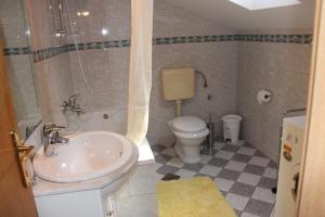 a bathroom with a sink and a toilet at Ferienwohnung Belafuza in Zadar in Zadar