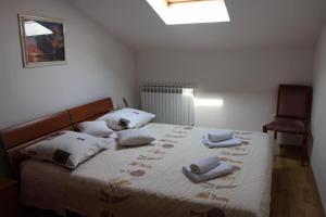 a bedroom with a bed with towels on it at Ferienwohnung Belafuza in Zadar in Zadar +7 photos