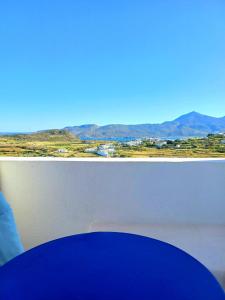 a window with a view of a field and mountains at Georgia Rooms Milos in Plaka Milou