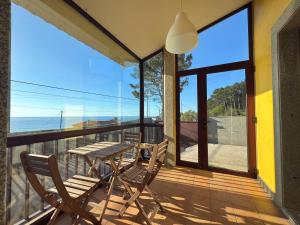 a patio with a table and chairs on a balcony at ROOMS El Descanso del Peregrino por la Costa in Oia