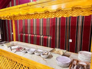 a table with plates and bowls of food on it at SCARLET LUXURY CAMP WADI RuM in Wadi Rum