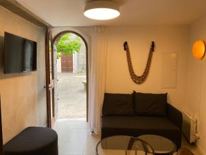 a living room with a couch and a glass table at La Nine in Aigne