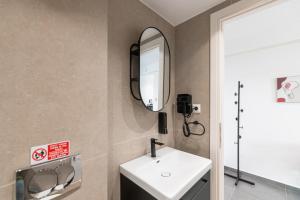a bathroom with a sink and a mirror at South Metro Suite in Athens +16 photos