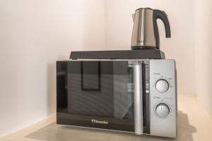 a black and silver microwave sitting on a counter at South Metro Suite in Athens