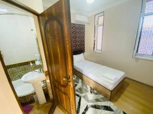 a small bathroom with a sink and a toilet at Mashhur in Bukhara