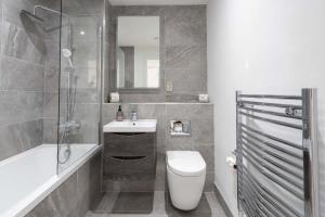 a bathroom with a toilet and a sink and a shower at 2 Bedroom Apartment Belfast City Center in Belfast