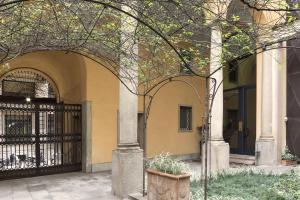 an entrance to a building with a black gate at Numa Milan Camperio in Milan