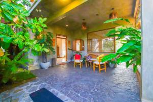 a room with a table and chairs and plants at Cinnamon Villas in Ambalangoda