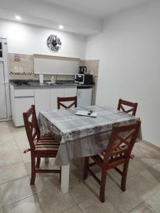 a kitchen with a table and two chairs and a kitchen with a stove at B&Z Departamentos in Federación +7 photos