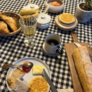 a table with a plate of bread and a cup of coffee at L'Armandine in Saint-Marcel-Bel-Accueil