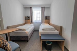 Łóżko lub łóżka w pokoju w obiekcie Hotel Anker