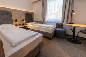 Łóżko lub łóżka w pokoju w obiekcie Hotel Anker