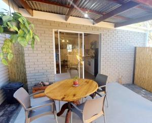 a wooden table and chairs on a patio at 177 on Church in Oudtshoorn