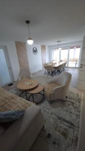 a living room with couches and tables and a dining room at Azur Perla in Sarajevo