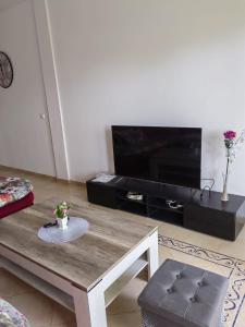 a living room with a coffee table and a flat screen tv at Saidia Marina Al Waha AP2 residence in Saidia  +7 photos