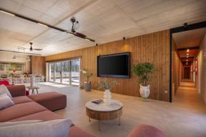 a living room with a couch and a tv on a wall at NEW! Contemporary Villa Fantazija – A Luxurious Retreat in Dicmo in Dicmo