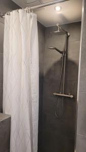 a shower with a white shower curtain in a bathroom at TinyWohnung im Pott in Castrop-Rauxel +18 photos