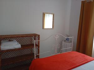 a bedroom with a red bed and a mirror at Saint Peter´s House in Angra do Heroísmo