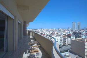 a balcony with benches and a view of a city at W-Aldorf in Casablanca