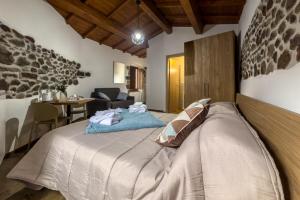 a bedroom with a large bed in a room at Sanadora Affittacamere Olistico in Santu Lussurgiu