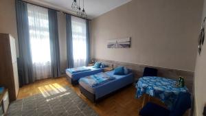 a living room with two blue couches and a couch at Wanta 2 Kołobrzeg in Kołobrzeg