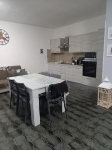 Una cocina con una mesa y sillas en una habitación. en La Perla Marina, en Quartu SantʼElena