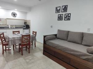 a living room with a couch and a table and a kitchen at B&Z Departamentos in Federación