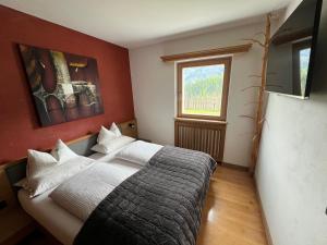 Postel nebo postele na pokoji v ubytování Ladin Apartment